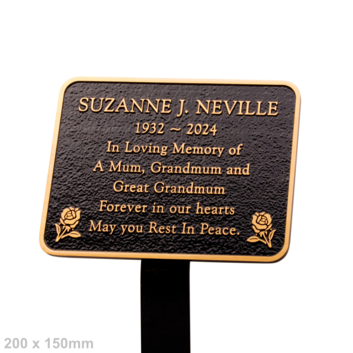 Cast bronze commemorative plaque with rounded corners and roses