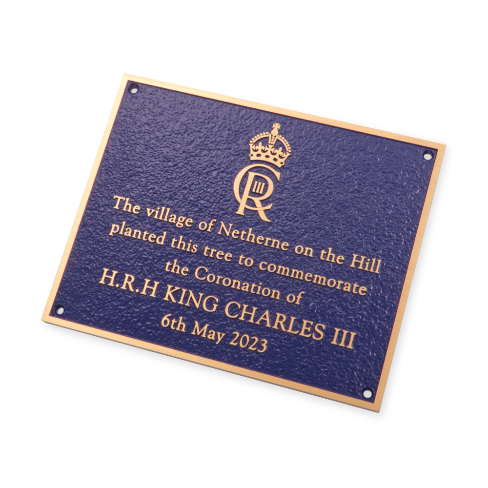 Cast bronze plaque with blue background and kings cypher.