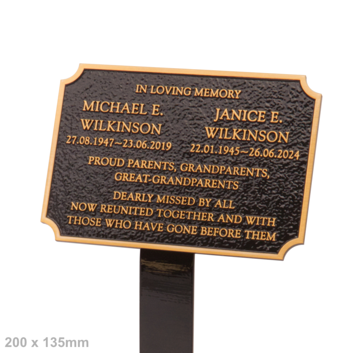 Cast bronze plaque with concaved corners, black background and ground spike for flower bed.