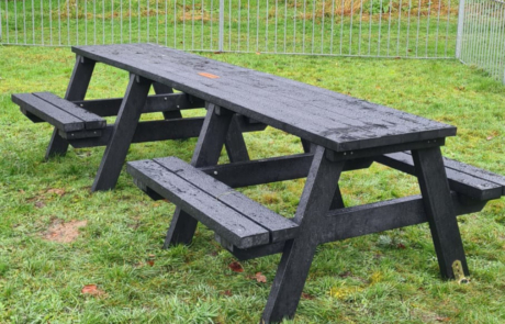 Recycled Plastic Picnic Bench in Black on Grass with a plaque central on the table top